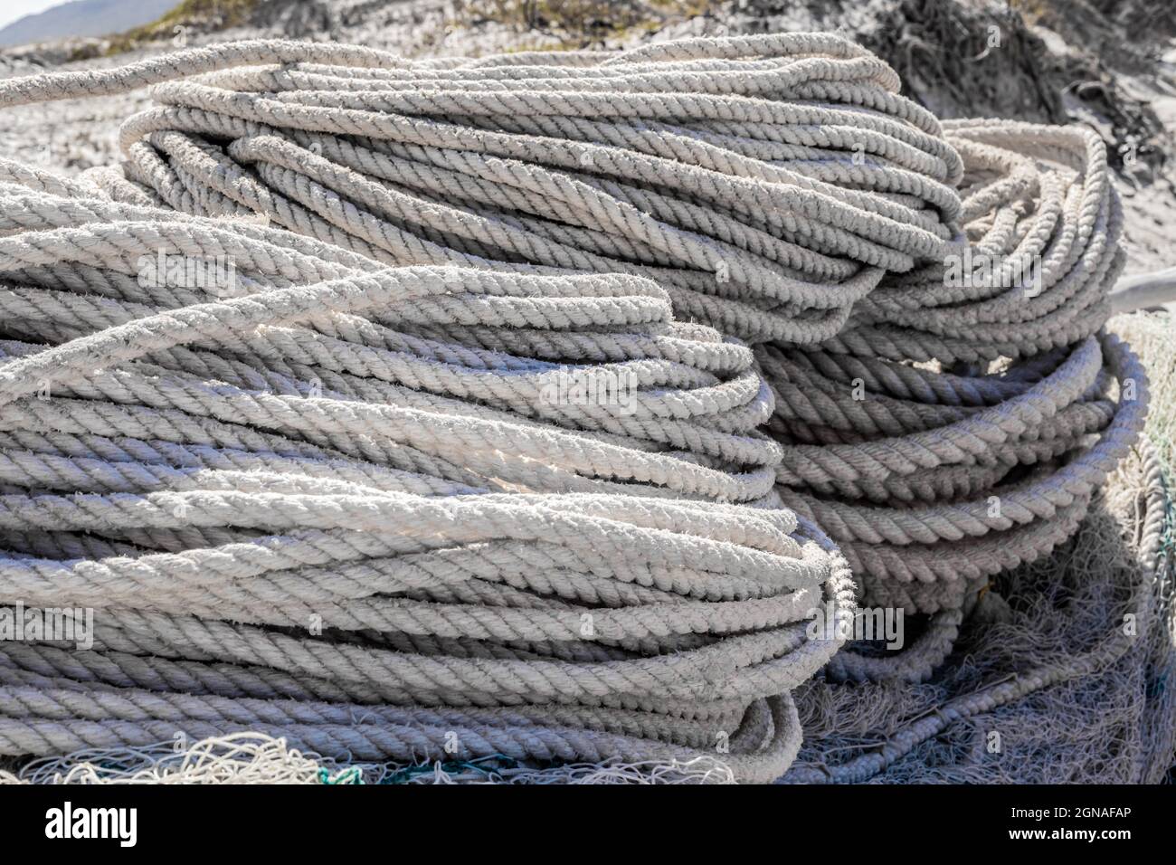 Macro close up of traditional fishing net and rope on small rowing boat ...