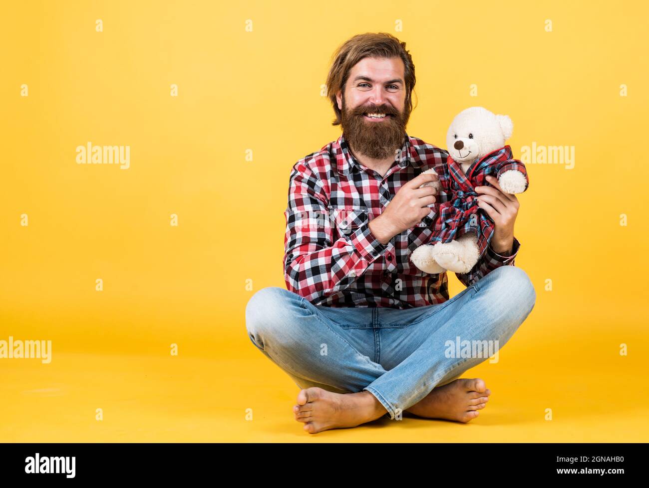 friendship concept. brutal mature hipster man play with toy. happy birthday. being in good mood. happy valentines day. cheerful bearded man hold teddy Stock Photo