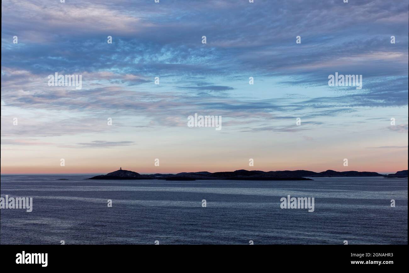 Low lying Islands silhouetted in the Early Morning Light on the Norwegian West Coast near to Bergen, on a calm Morning. Stock Photo
