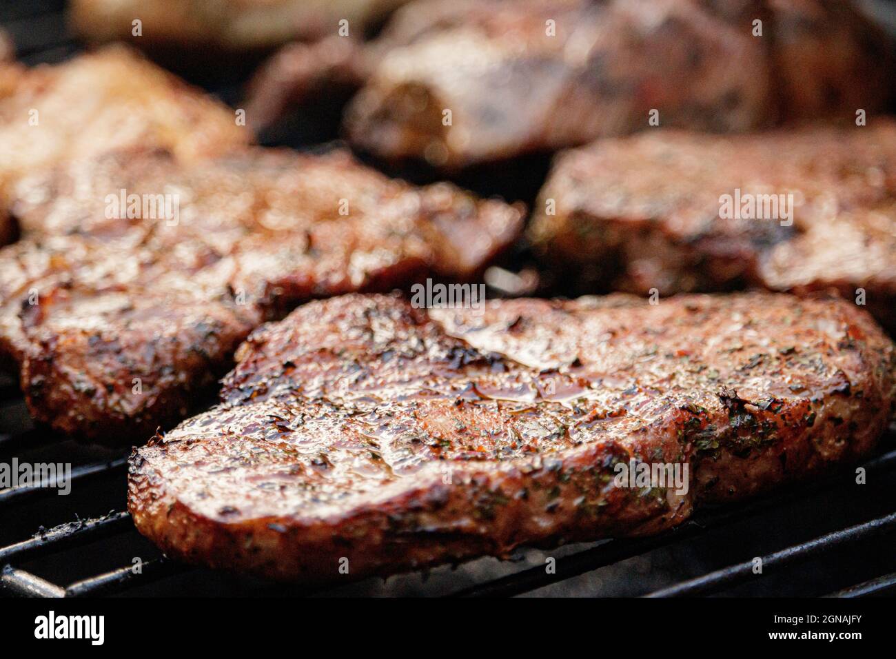 BBQ meat on flame gas grill Stock Photo Alamy