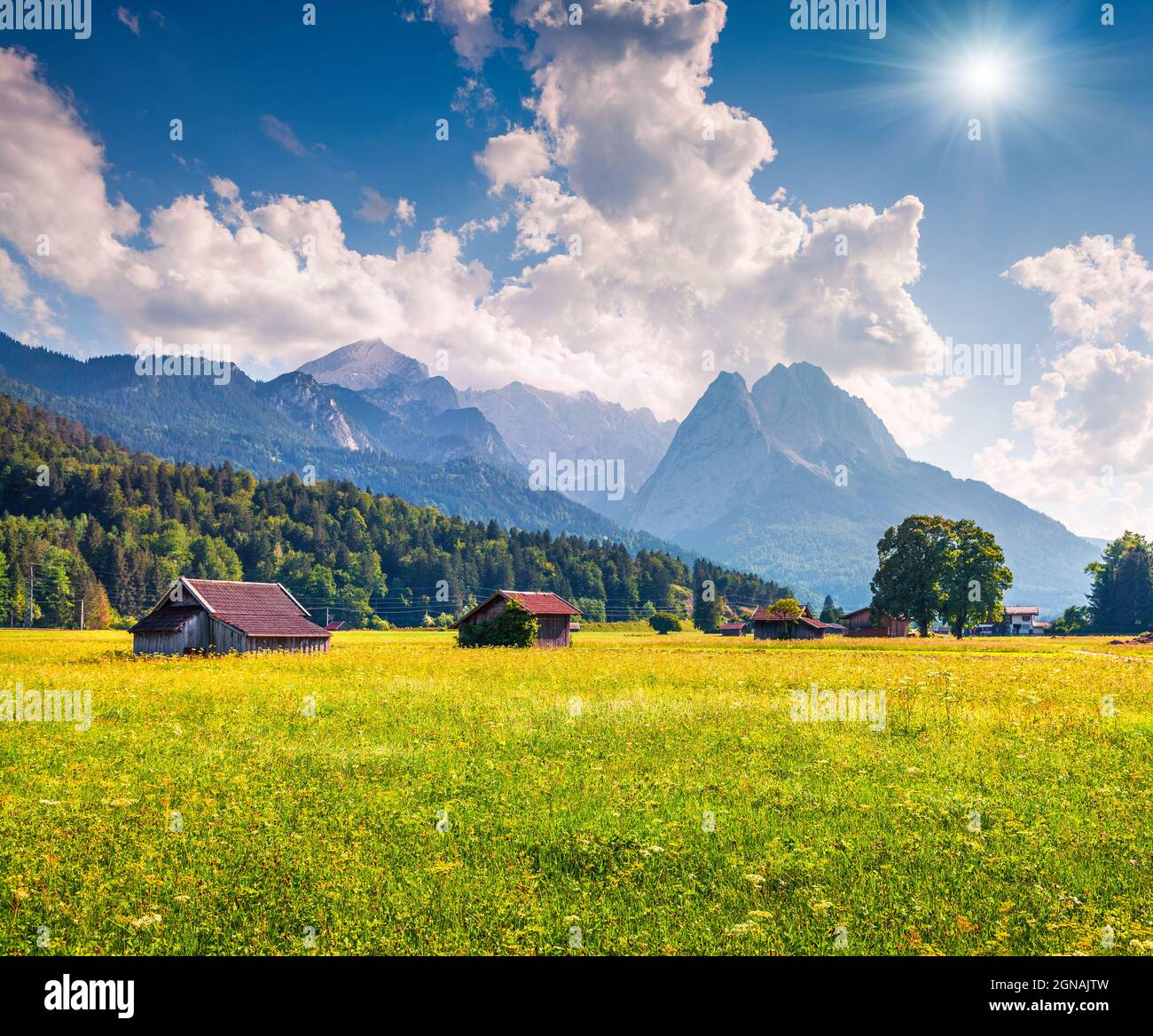 Sunny summer view of Garmisch-Partenkirchen mountain ski resort. Coloful outdoor scene with highest peak of the Wetterstein Mountains, Bavaria, German Stock Photo