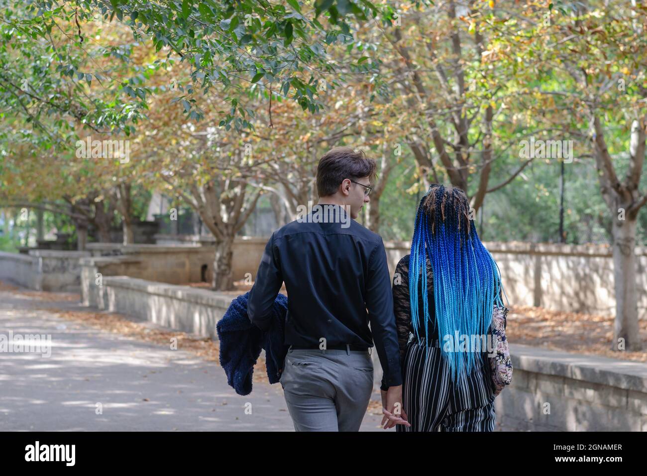 Couple walking talking in park hi-res stock photography and images - Alamy