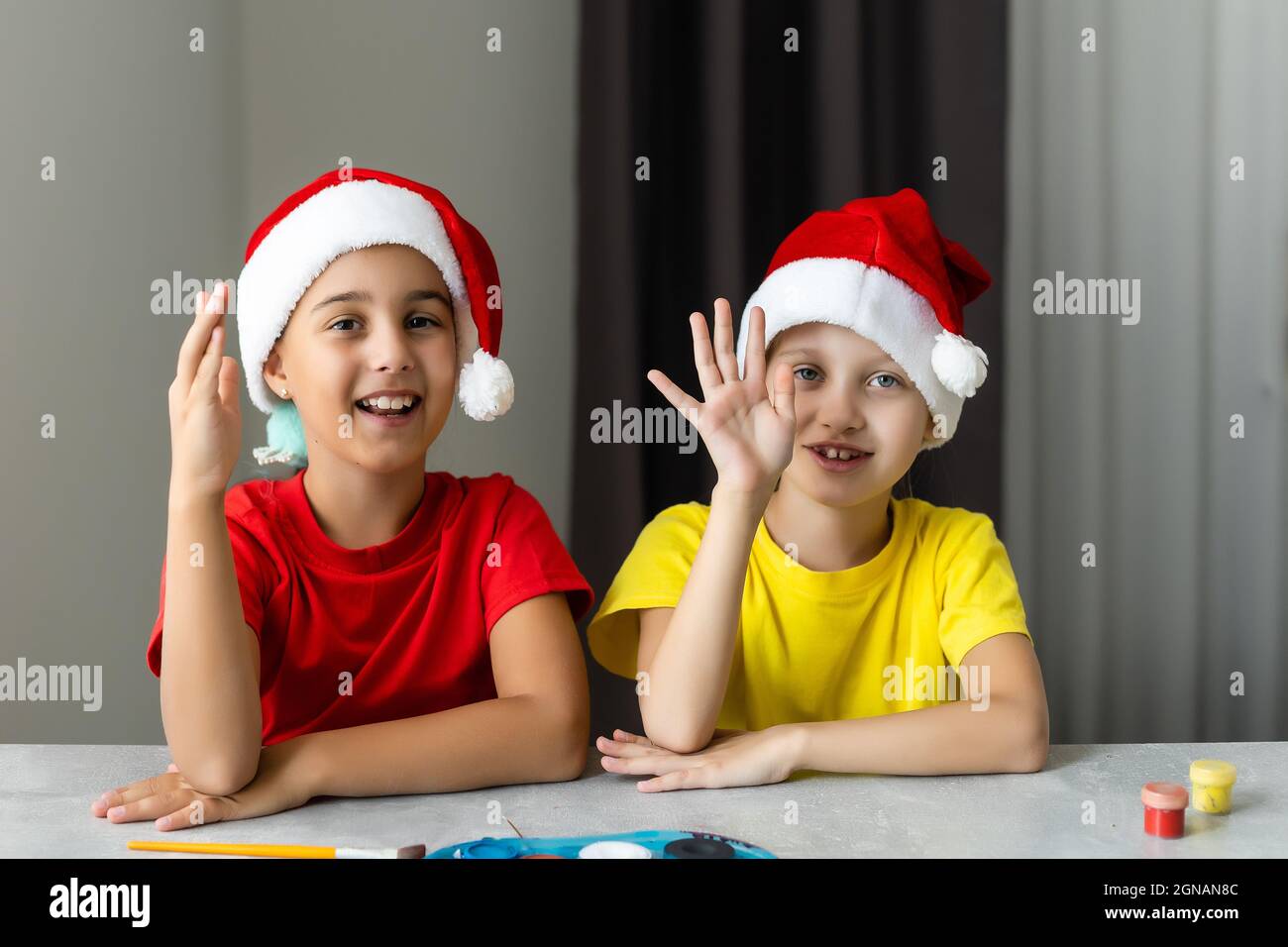 Two beautiful girls painted wooden Christmas figurines. Stock Photo