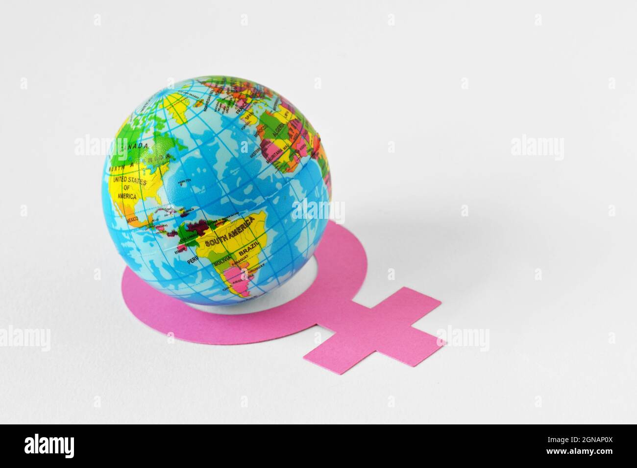 Earth globe inside the circle of female gender symbol - Concept of feminism and gender issues Stock Photo