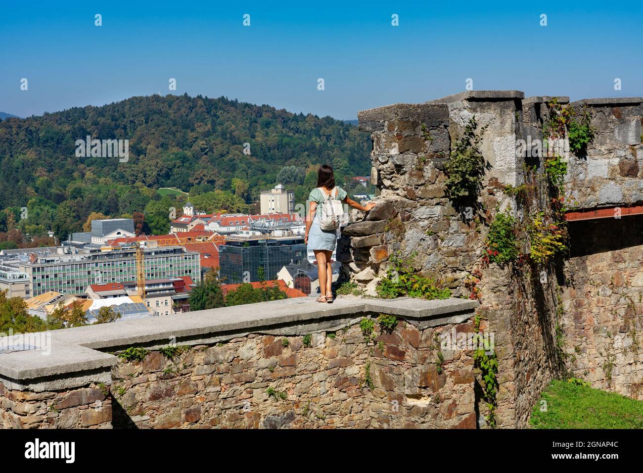 Arial View of the city of Ljubljana from the castle hill in Slovenia with tourist woman Stock Photo