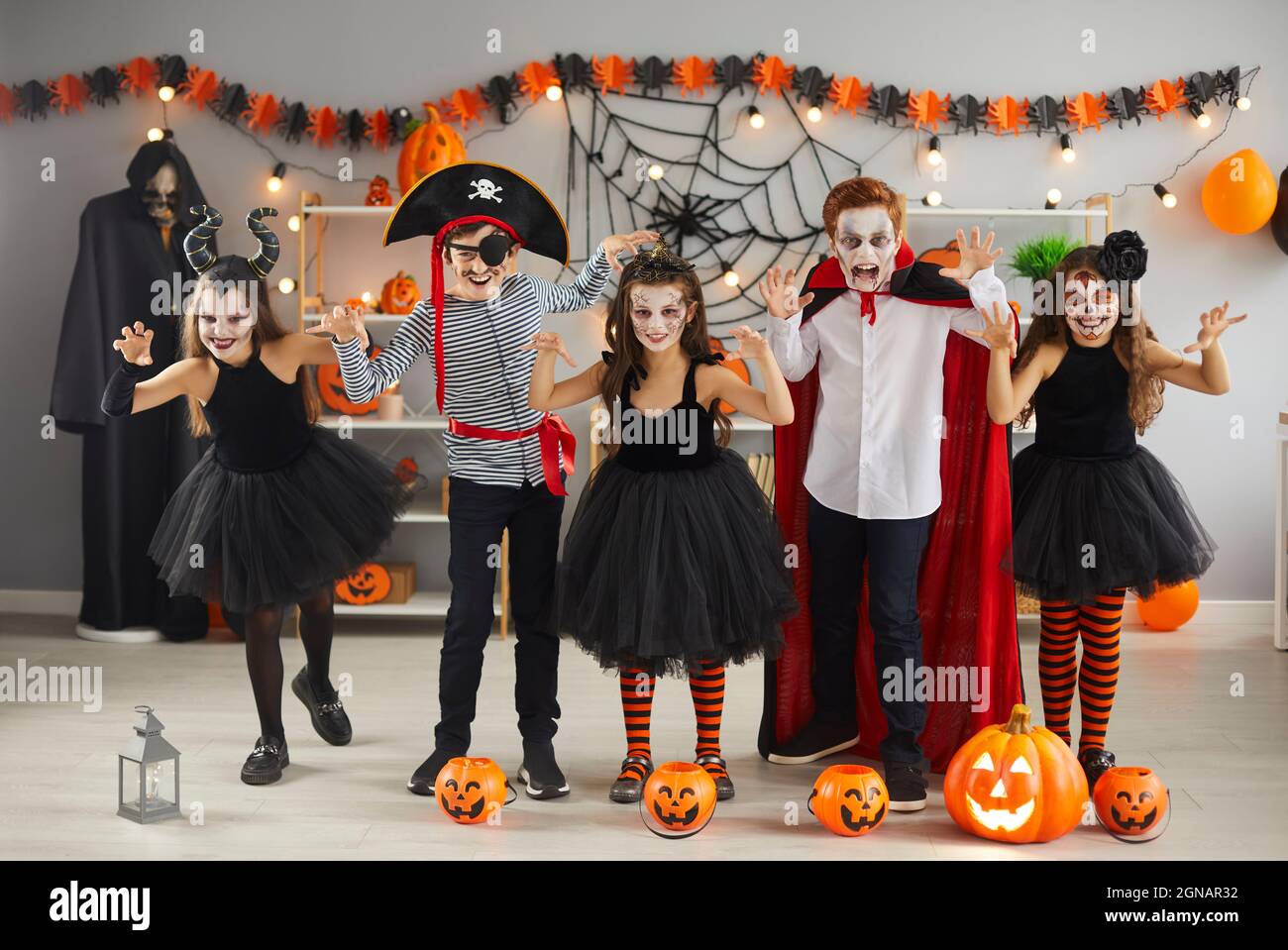 Portrait of creative little boys and girls who scare during Halloween party at home. Stock Photo