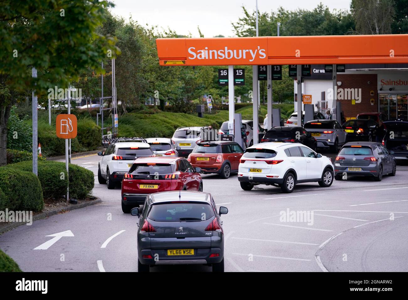 Queues at a Sainsbury's Petrol Station in Colton, Leeds. Drivers are being urged by the Government to "buy fuel as normal", after the lorry driver shortage hit supplies. BP said a "handful" of its filling stations are closed due to a lack of fuel available, while Esso owner ExxonMobil also said a "small number" of its Tesco Alliance petrol forecourts have been impacted. Picture date: Friday September 24, 2021. Stock Photo