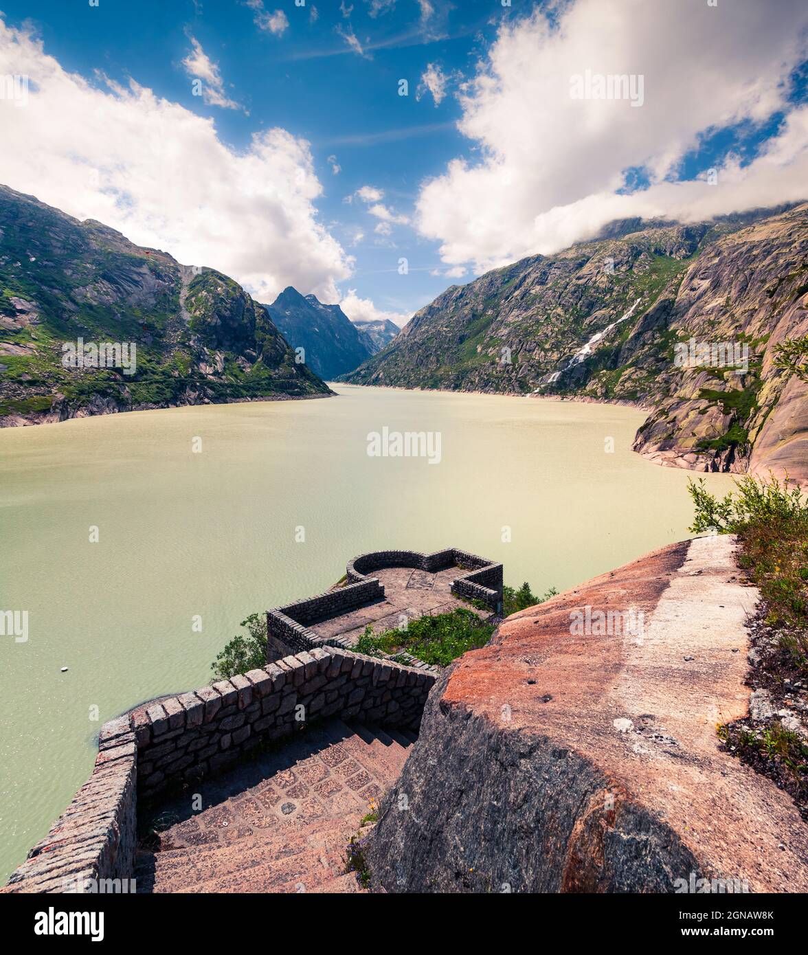 Dam on the Grimselsee reservoir on the top of Grimselpass. Sunny summer morning in Swiss Alps,  Interlaken-Oberhasli administrative district in the ca Stock Photo