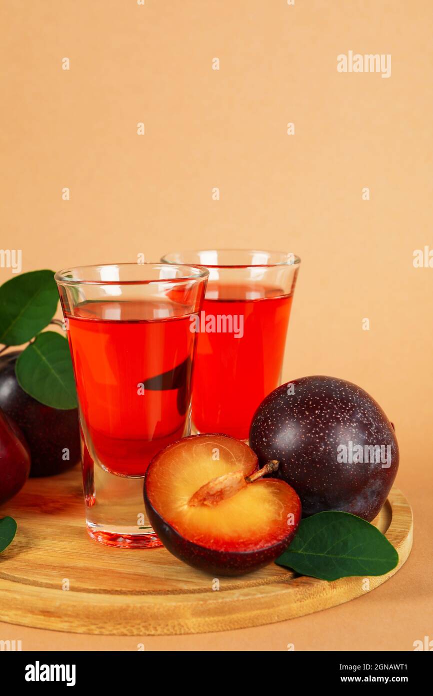 Plum brandy shots and ingredients on beige background Stock Photo Alamy