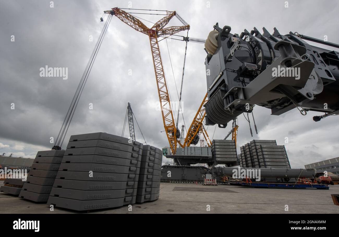 Ehingen, Germany. 26th Aug, 2021. Counterweights weighing several tons hang from a crawler crane