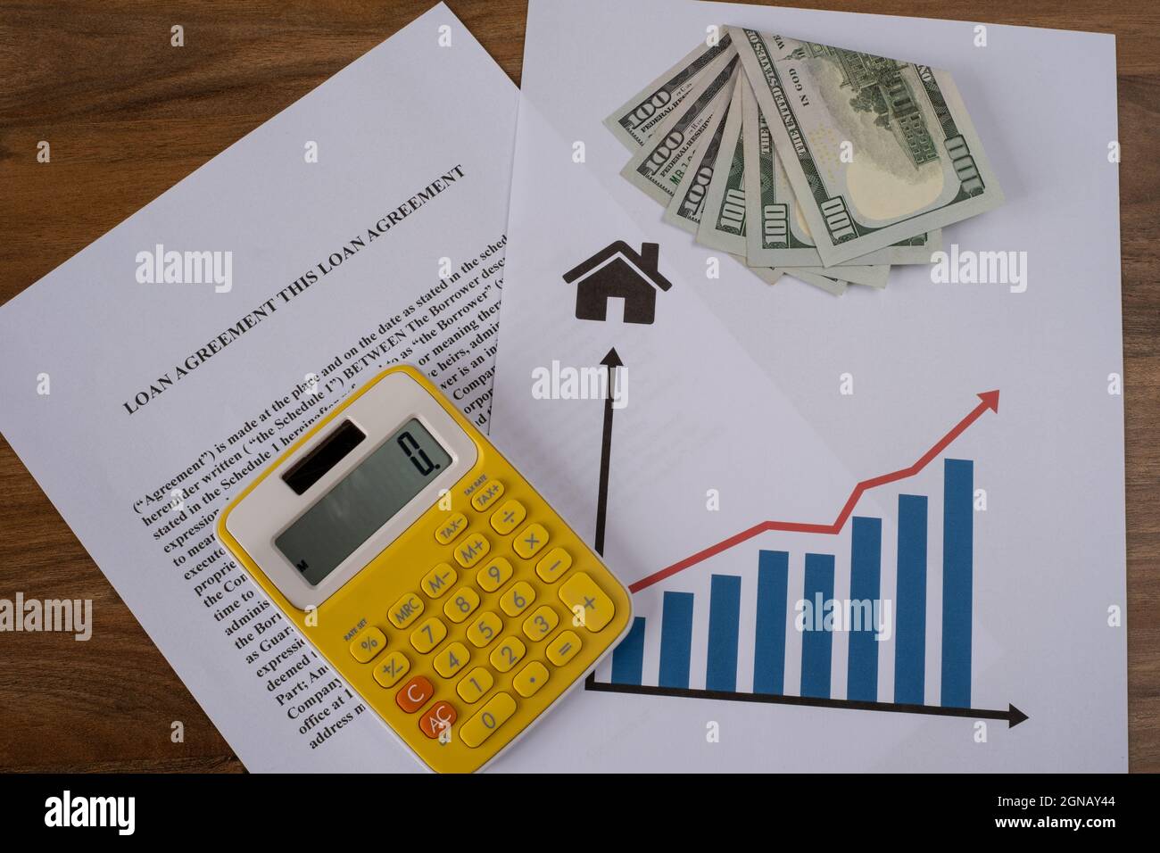 Loan agreement, cash, real estate chart and calculator top view on the