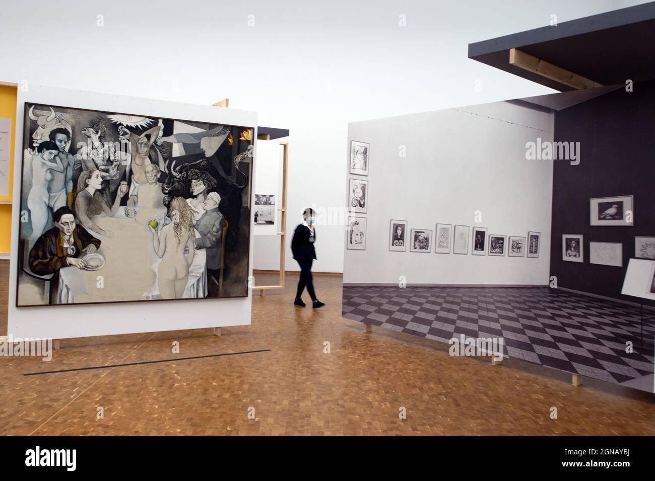 Cologne, Germany. 24th Sep, 2021. A woman walks past the painting 'Totenmahl mit Picasso' by Renato Guttuso from 1973. Picasso was appropriated by both the Communist Eastern Bloc and the West. He was a member of the French Communist Party, but lived in the West. The exhibition shows how different the image of Picasso was in the Federal Republic and in the GDR. Credit: Federico Gambarini/dpa - ATTENTION: Only for editorial use in connection with current reporting and only with full mention of the above credit/dpa/Alamy Live News Stock Photo