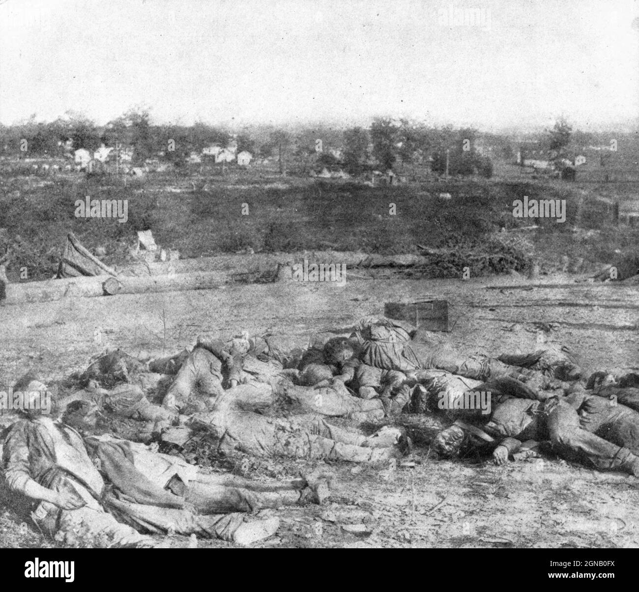 The Gathered Confederate Dead Before Battery Robinett taken the morning after their desperate attempt to carry the works by assault. No man can look at this awful picture and wish to go to war. These men, a few hours before, were full of life and hope and courage. Without the two last qualities they would not be lying as they are pictured here. In the very foreground, on the left, lies their leader, Colonel Rogers, and almost resting on his shoulder is the body of the gallant Colonel Ross. from the book ' The Civil war through the camera ' hundreds of vivid photographs actually taken in Civil Stock Photo