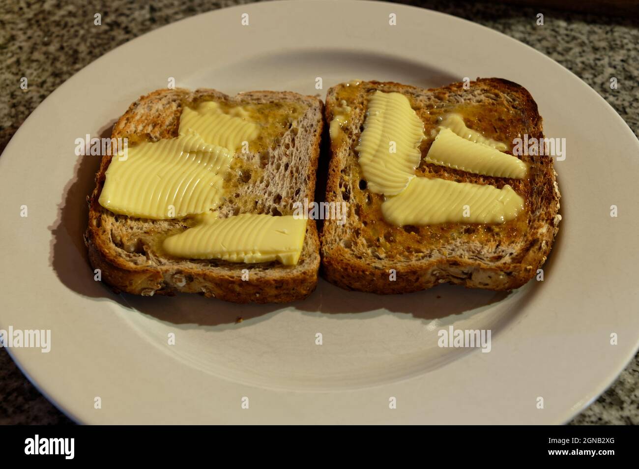 Toast has been generously buttered while it is still warm Stock Photo
