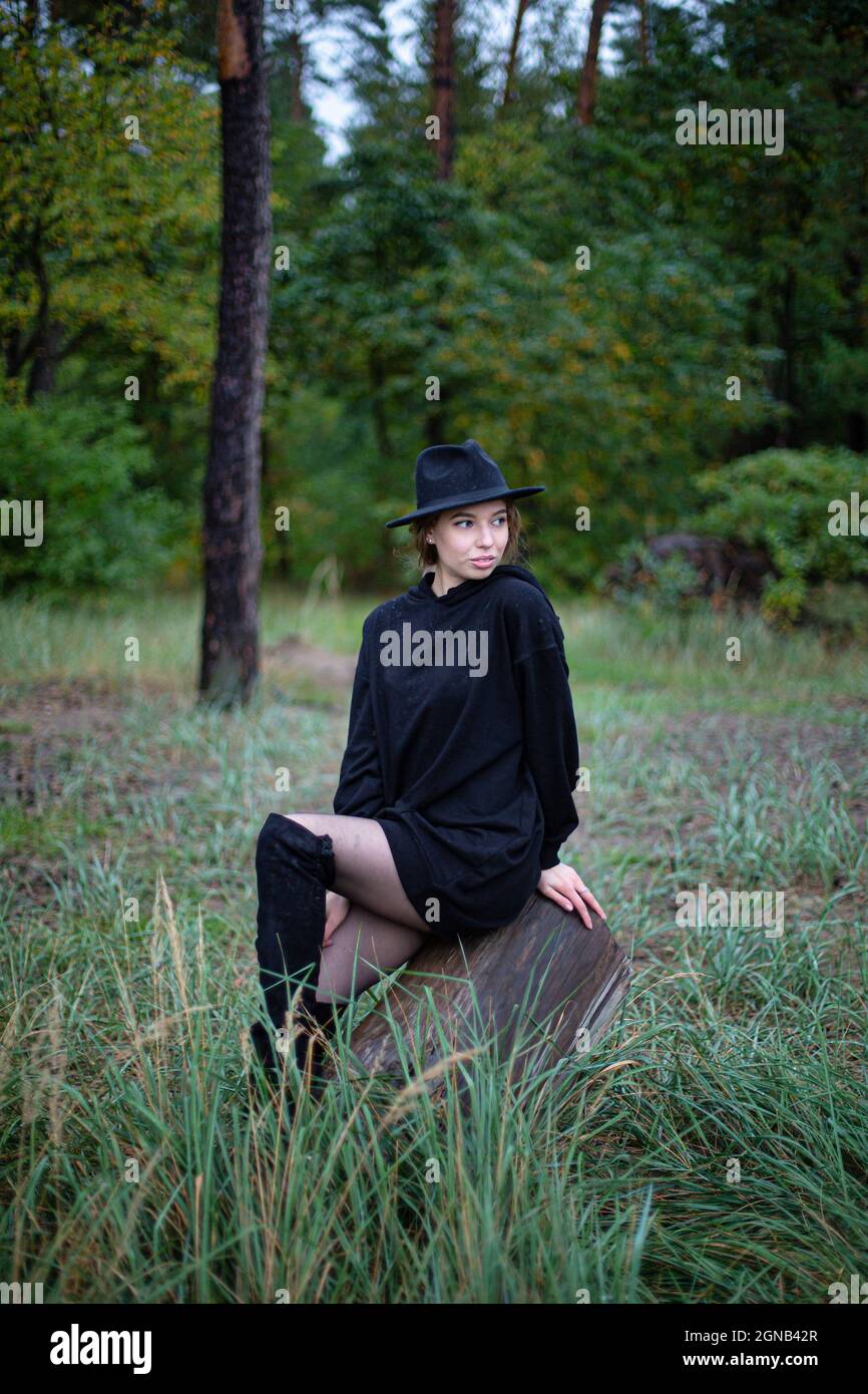 Young woman in dark clothes hi-res stock photography and images - Alamy