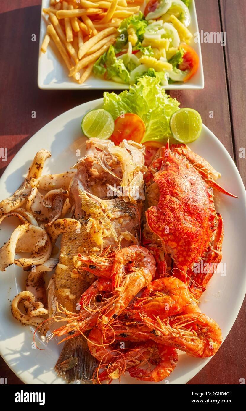 Grilled seafood platter with crab, fish, prawn and squid with lemon. Stock Photo