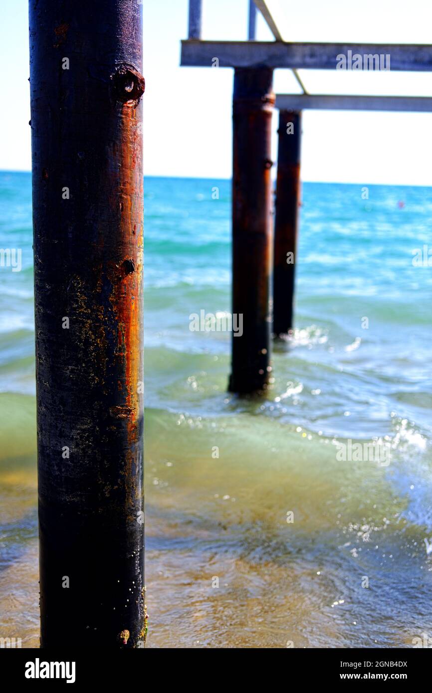 Wooden Columns at Sea in a Sunny day Stock Photo