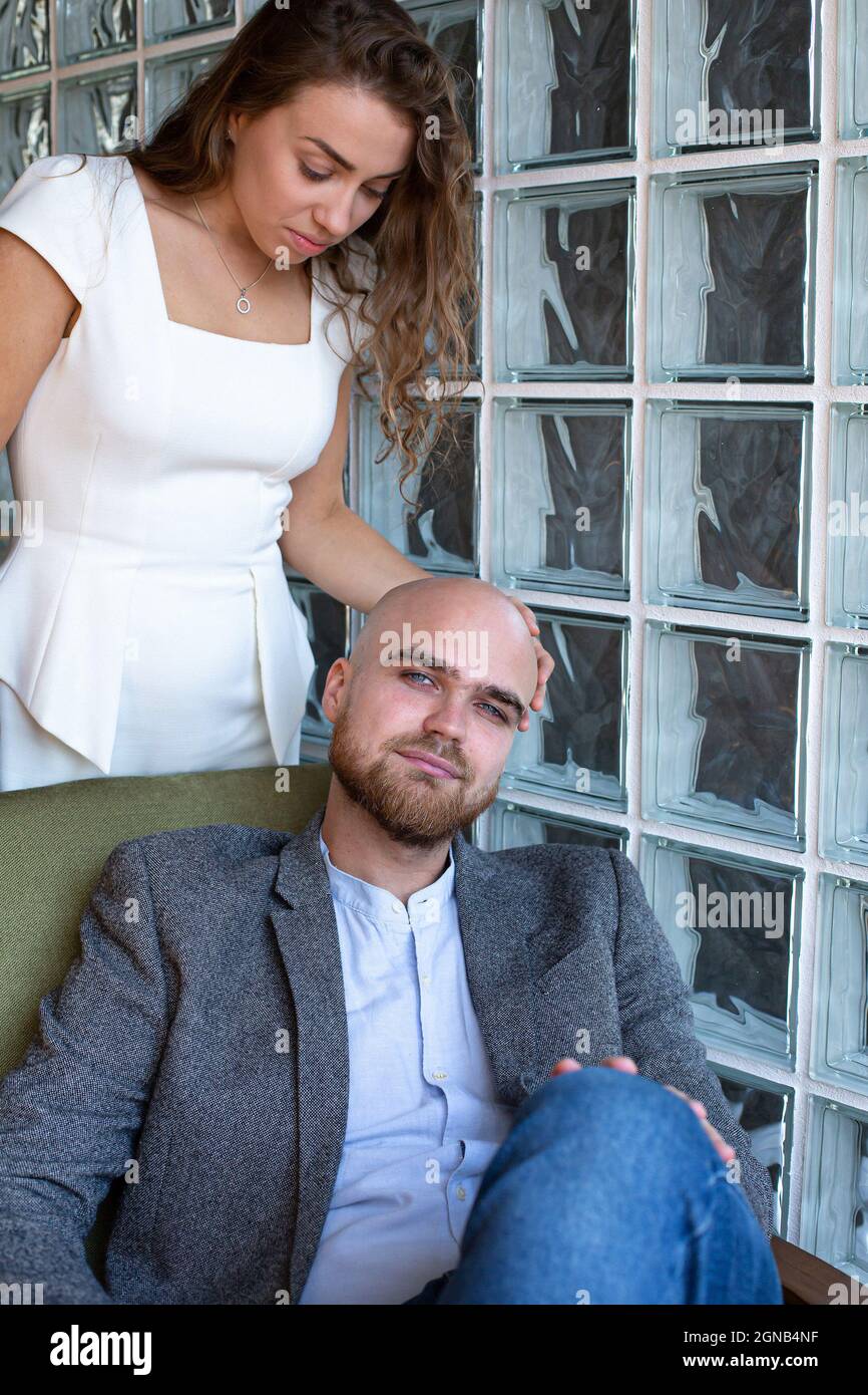 Woman standing behind man sitting hi-res stock photography and images ...