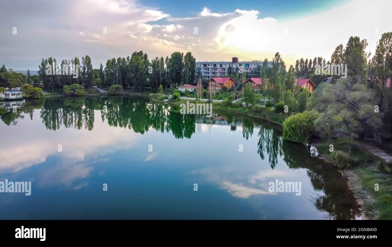Idyllic Summer Setting Idyllic summer landscape with lake near mountain with reflection from ...