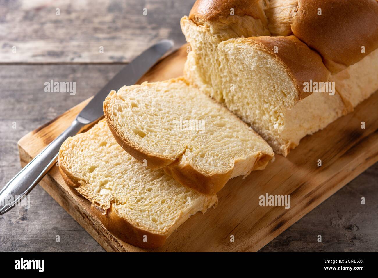 Braided egg bread on wooden table Stock Photo