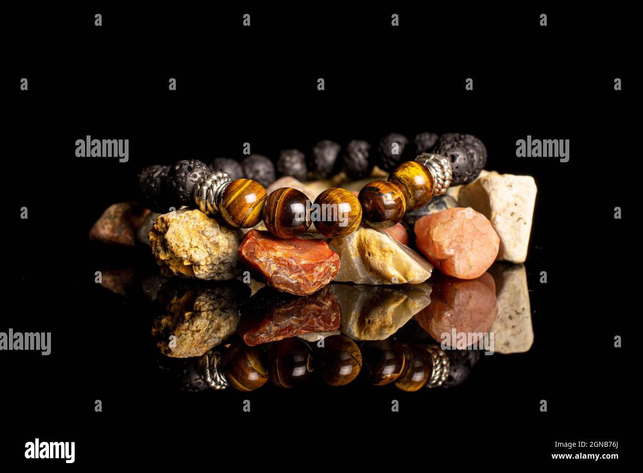 Semi precious stone bracelet with colorful rocks isolated on black glass Stock Photo