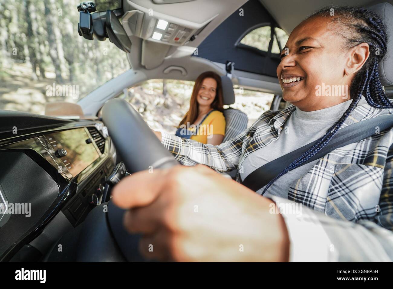 Multiracial senior women having fun on the road in camper van - Focus on  african woman face Stock Photo - Alamy