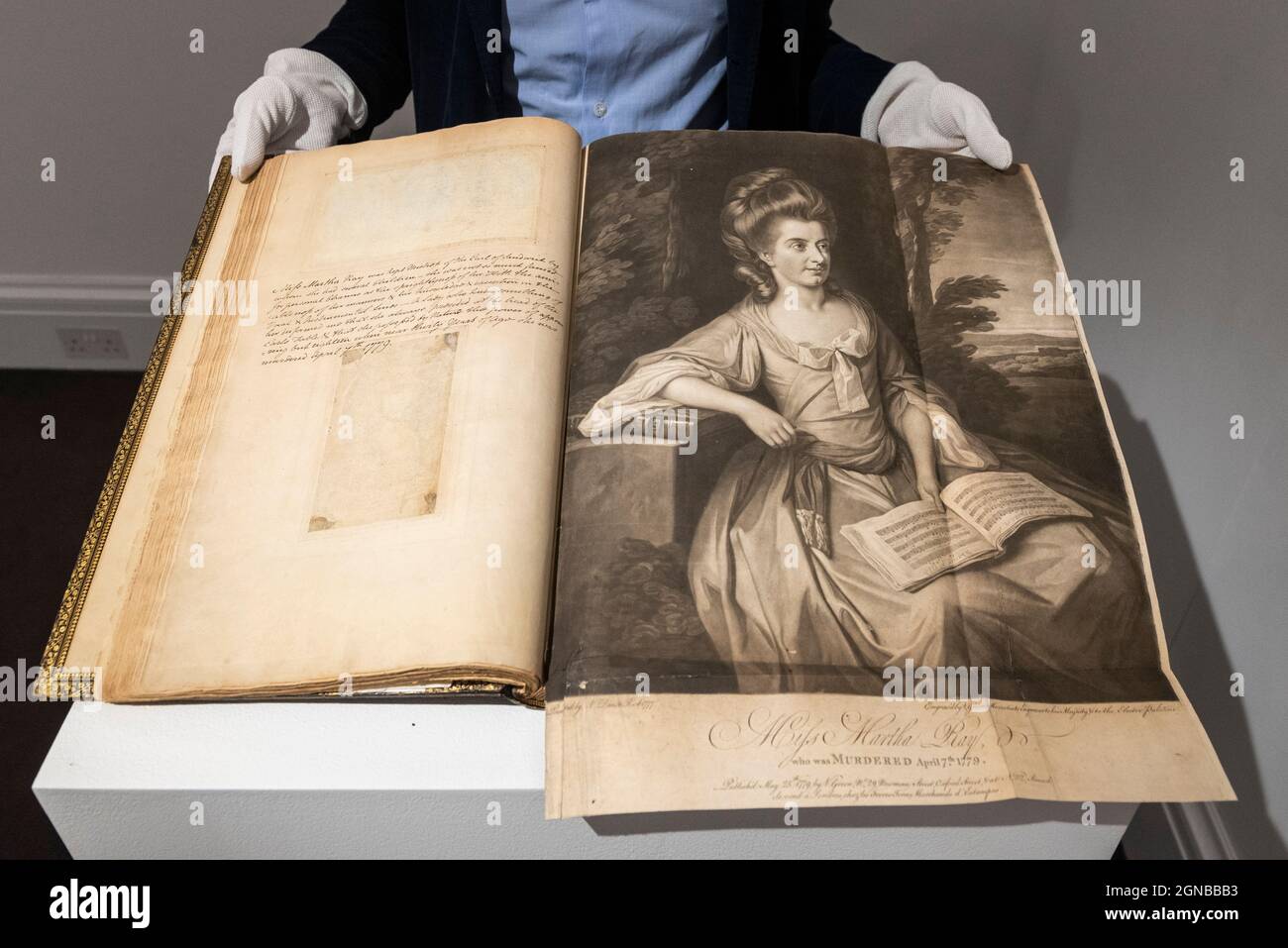 London, UK.  24 September 2021. A technician presents one of two volumes called 'Remarkable Characters' (Est $100,000-150,000), containing 460 prints brought together by WIlliam Esdaile, the most important print collector of his day. Preview of a collection spanning the history of magic from celebrity magician Ricky Jay.  The works are being shown in Sotheby’s, New Bond Street, ahead of their auction in New York on 27 and 28 October. Credit: Stephen Chung / Alamy Live News Stock Photo