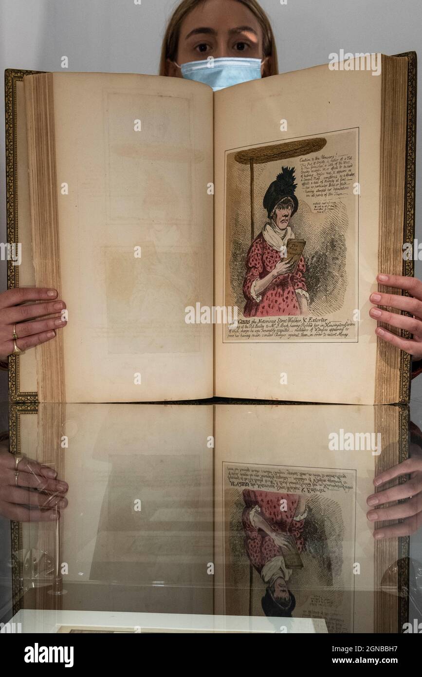 London, UK.  24 September 2021. A staff member presents one of two volumes called 'Remarkable Characters' (Est $100,000-150,000), containing 460 prints brought together by WIlliam Esdaile, the most important print collector of his day. Preview of a collection spanning the history of magic from celebrity magician Ricky Jay.  The works are being shown in Sotheby’s, New Bond Street, ahead of their auction in New York on 27 and 28 October. Credit: Stephen Chung / Alamy Live News Stock Photo