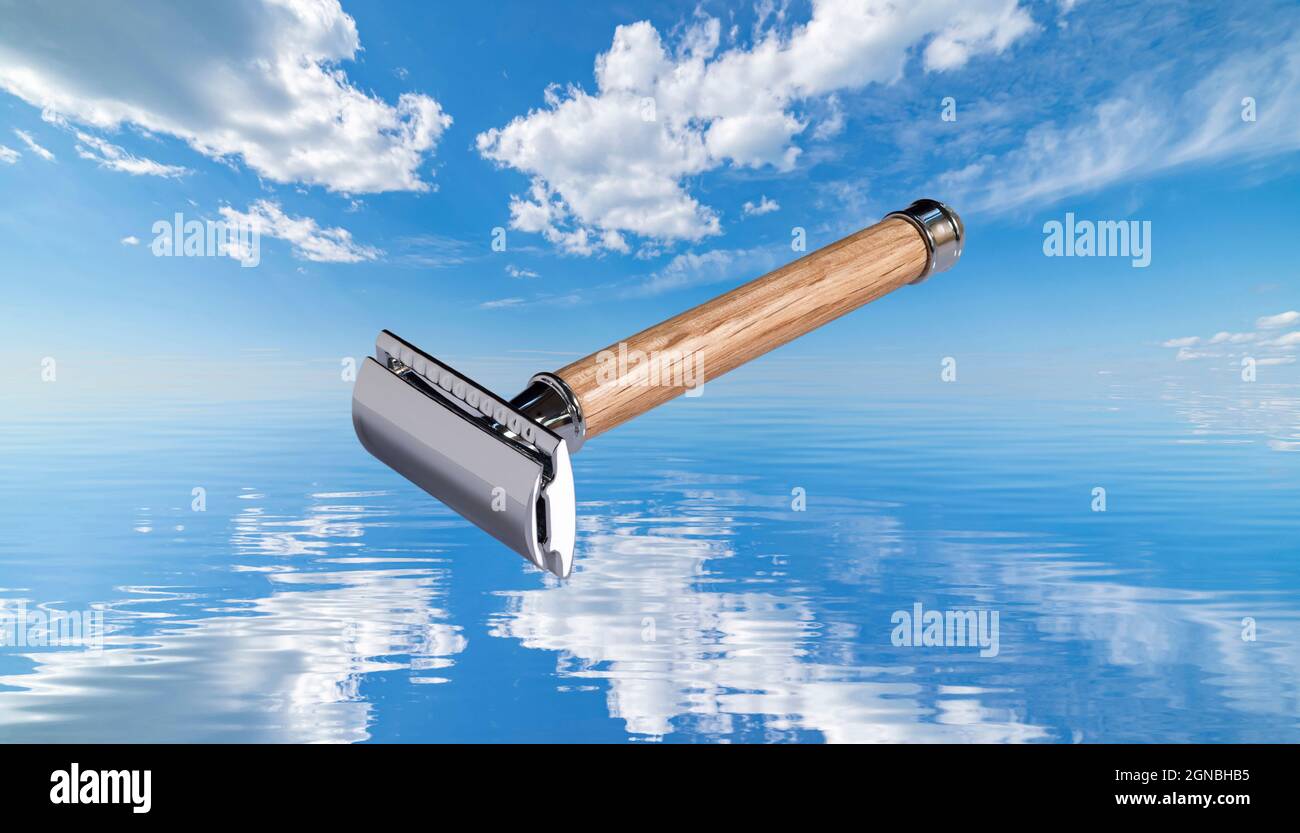 shaving razor with wooden handle on sea and sky background Stock Photo
