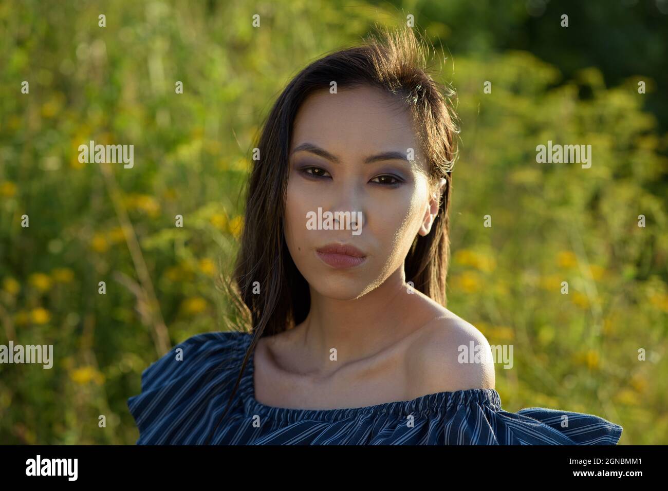 Sunny portrait of young asian woman Stock Photo