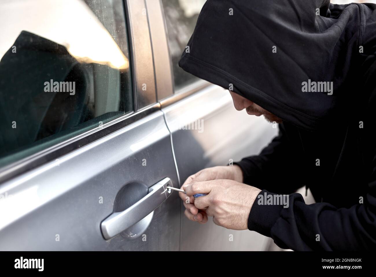 Unrecognizable Car thief steal car breaking door criminal job burglar Hijacks Auto thief is