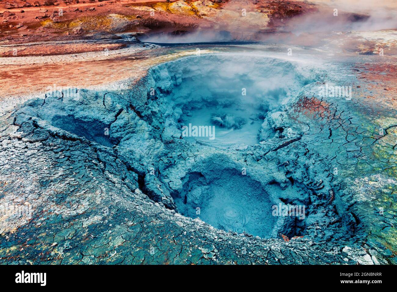 Boiling swamp in Geothermal valley Hverarond, located near Reykjahlid village in north of Iceland. Exotic desert landscape on volcanic ground. Artisti Stock Photo