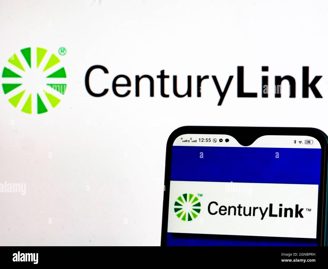 In this photo illustration, CenturyLink, Inc. logo seen displayed on a smartphone and in the background. Stock Photo