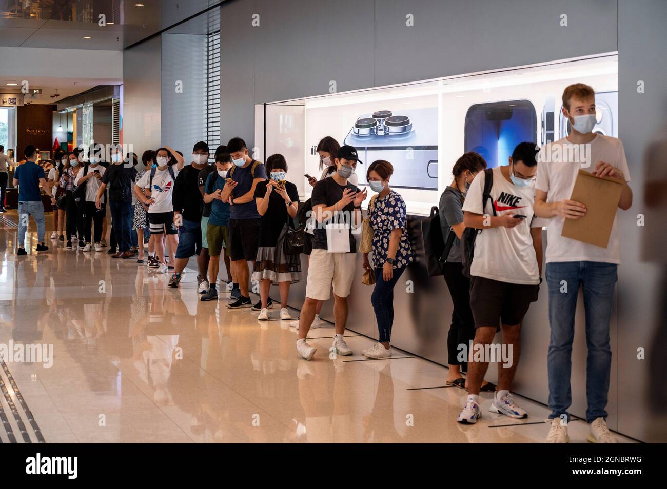 Shoppers queue at an Apple store during the launch day of the new ...