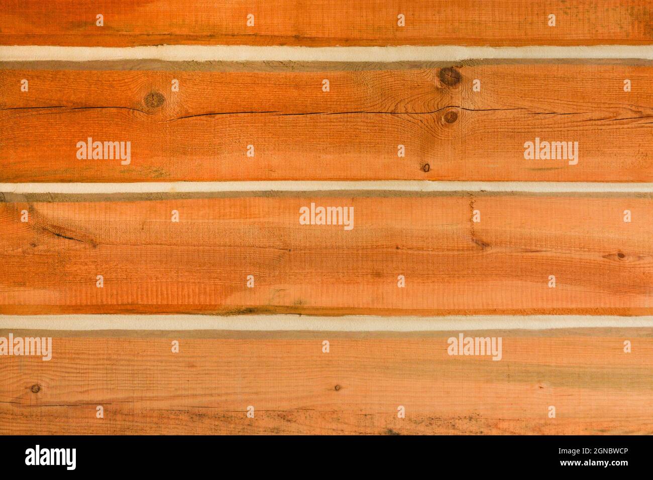 Wall of a house built with timber bars Stock Photo