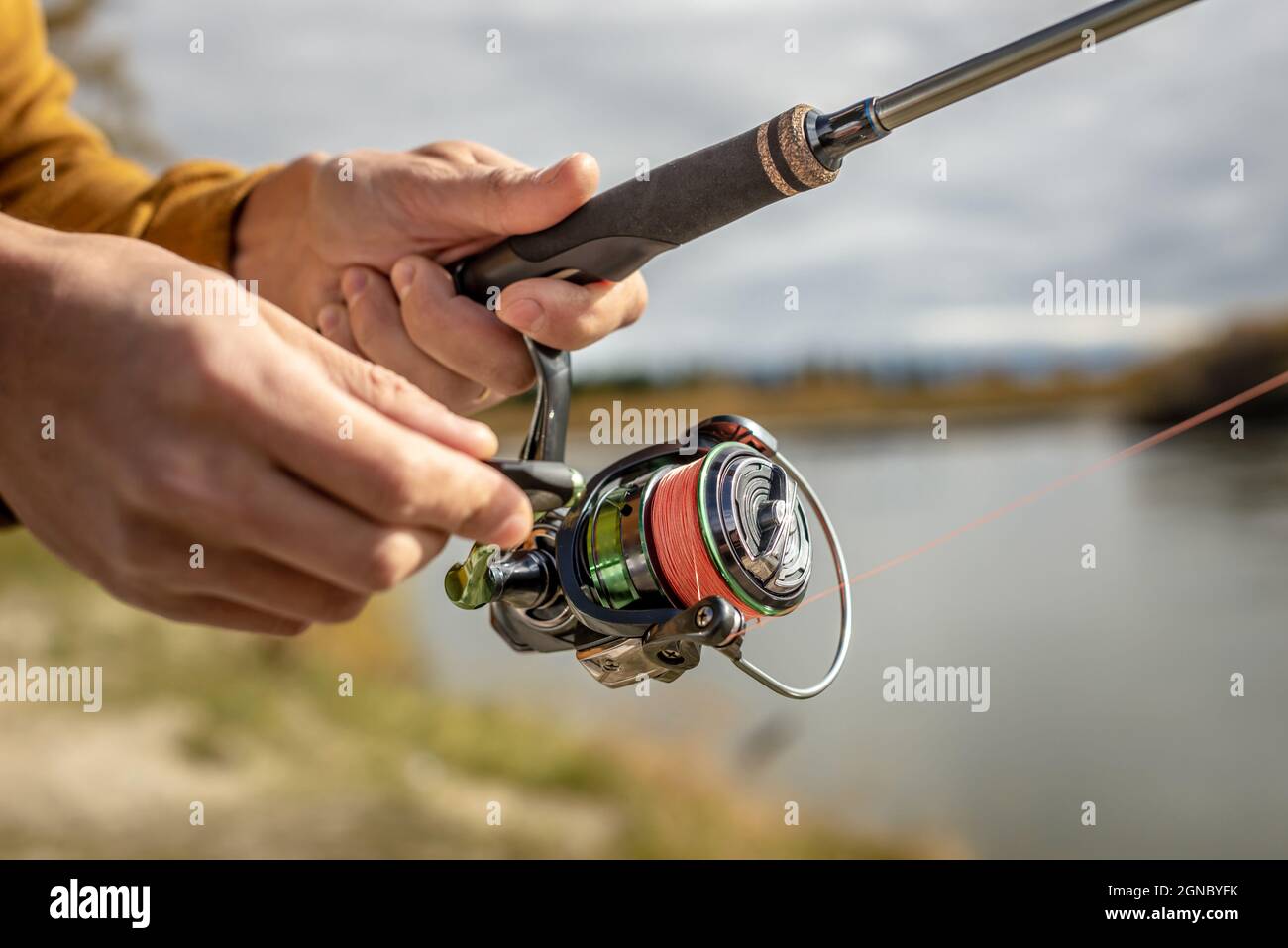 Male hands of a fisherman are holding a spinning closeup. Concept of  fishing in the autumn forest, outdoor recreation, pastime, hobby Stock  Photo - Alamy