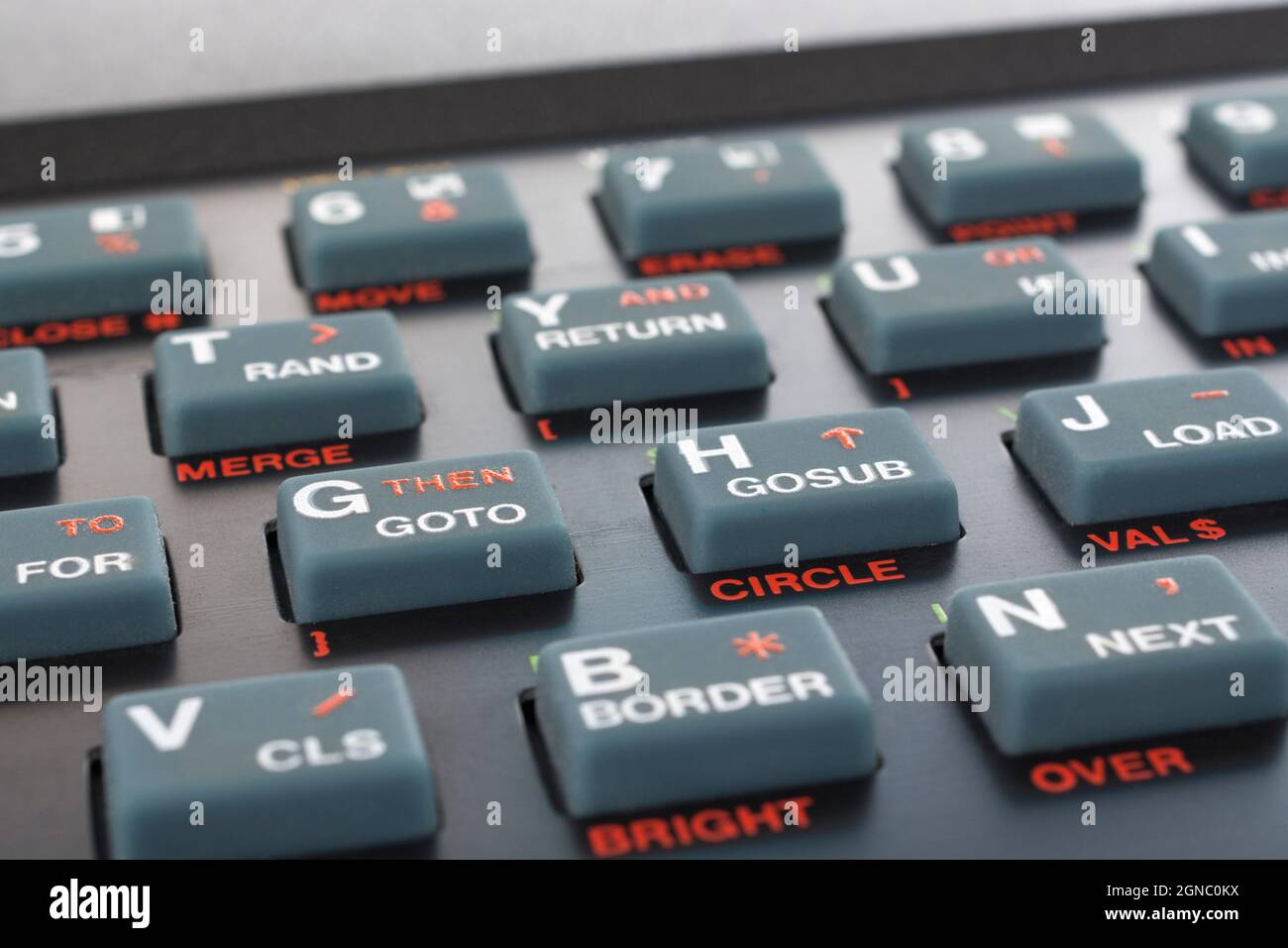 Sinclair ZX Spectrum keyboard close-up. Focus on Basic THEN / GOTO command key. Vintage 8-bit home computer from 1980s (see Notes). Stock Photo