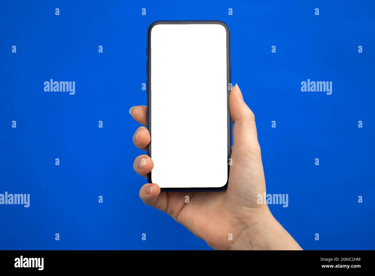 Mobile phone mockup screen on a blue background, copy space Stock Photo