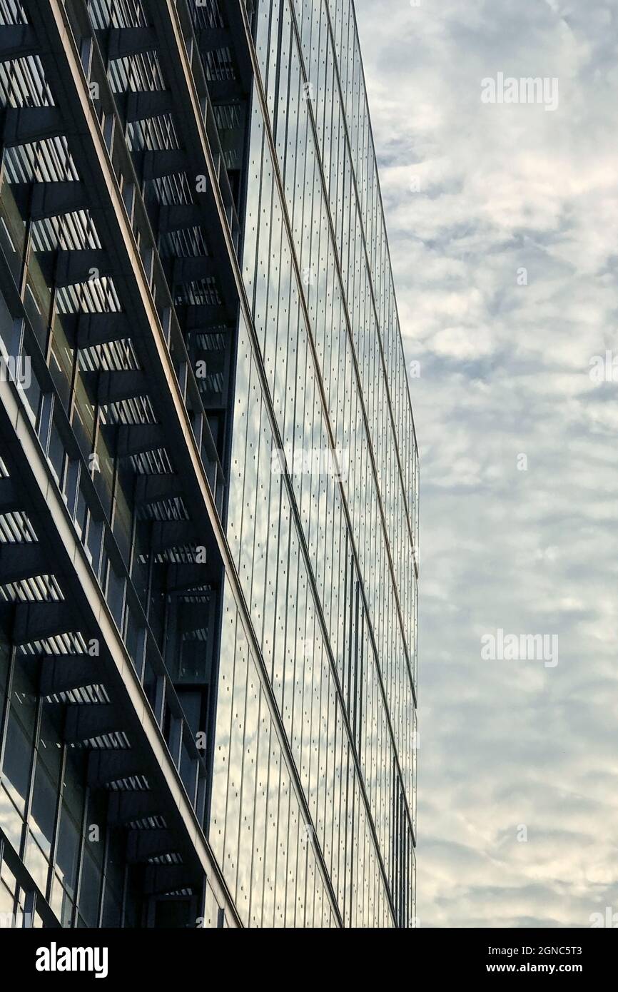 Vertical low angle shot of high-rise modern buildings under a cloudy ...