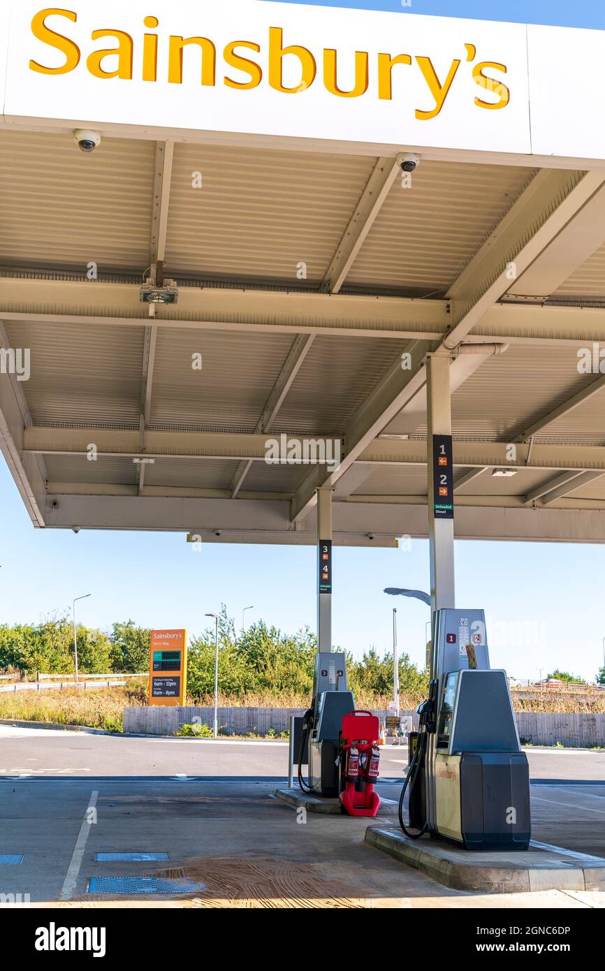 Forecourt of a Sainsbury's petrol station in the daytime, completely empty, during the petrol