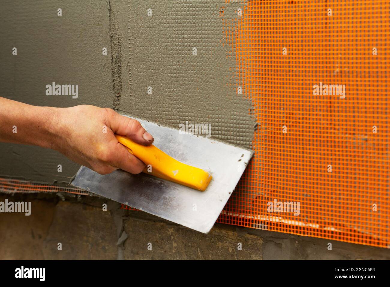 The worker performs the reinforcement and filling of the walls. Stock Photo