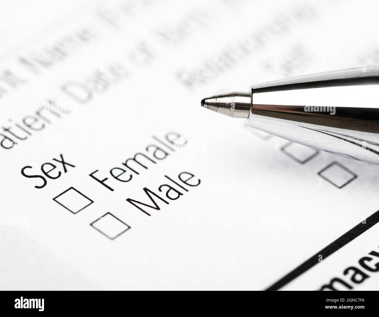 Pen over male female gender option checkboxes in a document form Stock Photo