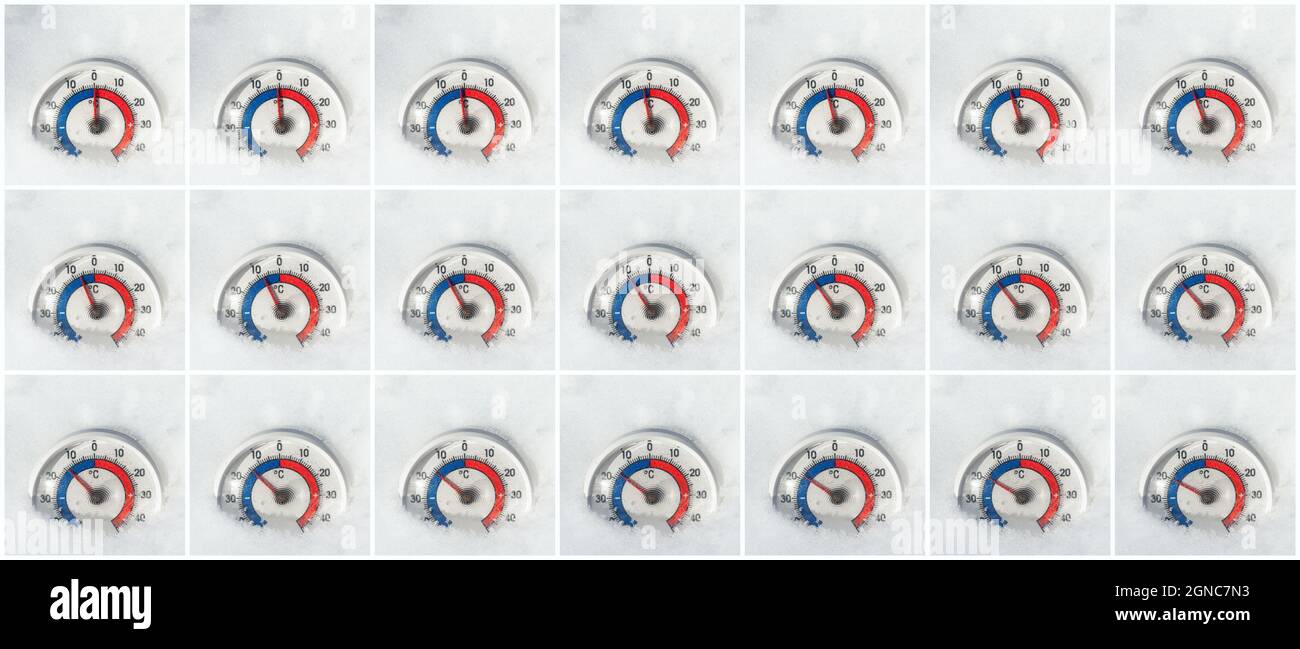 Thermometer with Celsius scale placed in the snow showing temperature drops from zero to minus 20 degrees Stock Photo