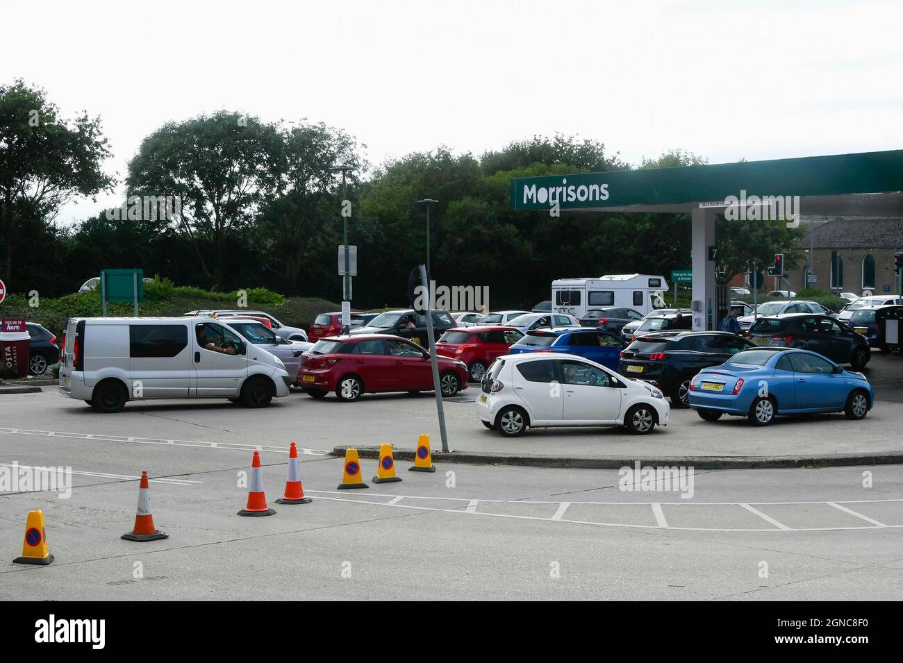 Bridport, Dorset, UK.  24th September 2021.  The forecourt at Morrisons petrol station at Bridport in Dorset is packed with vehicles as drivers panic buy fuel.   Picture Credit: Graham Hunt/Alamy Live News Stock Photo