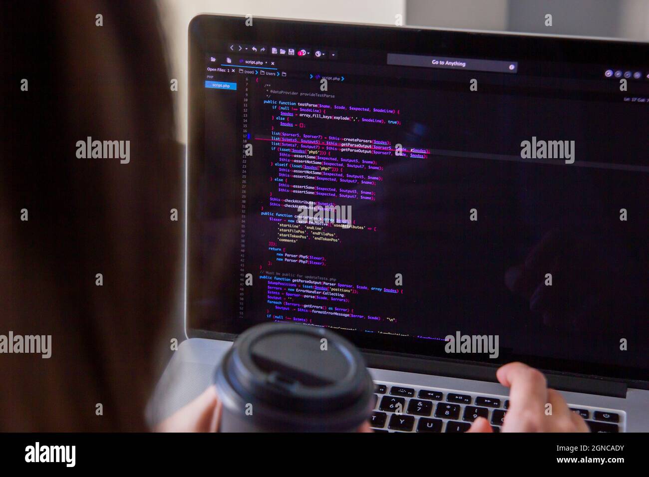 A programmer coding on a laptop in the workplace Stock Photo