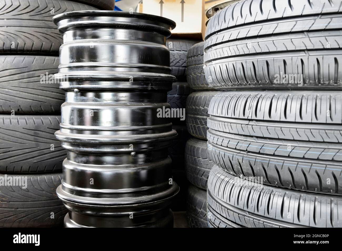 Stack of car tyres and wheel rims in an auto repair shop garage Stock Photo Alamy