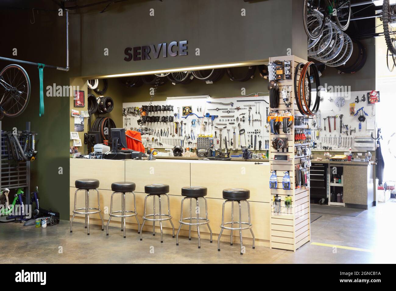 Cycle repair shop interior tool boards and tools at a service counter Stock Photo Alamy