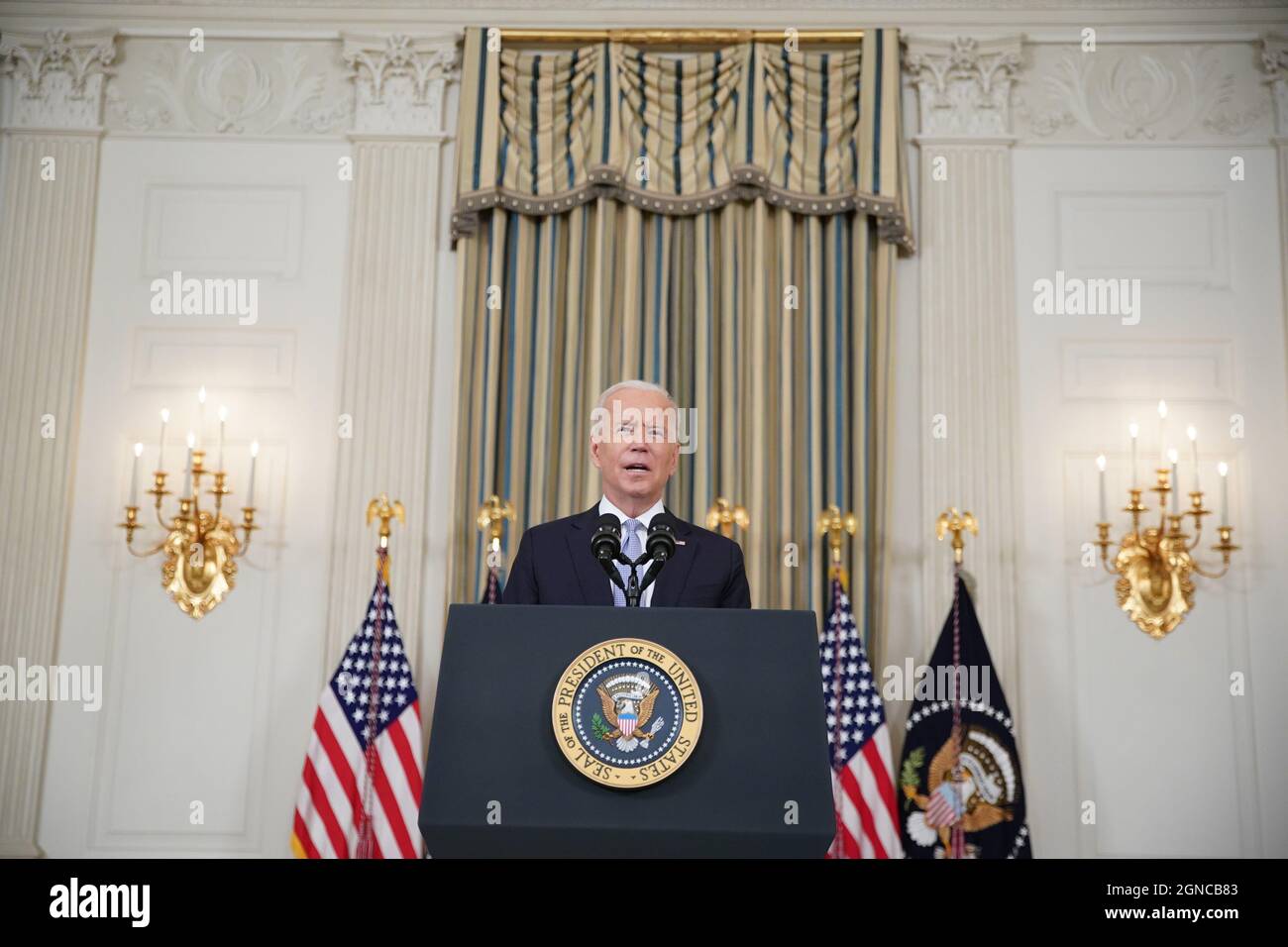 U.S. President Joe Biden speaks in the State Dining Room of the White House in Washington, DC, U.S., on Friday, Sept. 24, 2021. The U.S. will begin giving Covid-19 booster shots to millions of Americans today, a watershed moment in the nation's battle against the pandemic that officials hope will beat back another brutal winter wave of infections. Credit: Al Drago/Pool via CNP /MediaPunch Stock Photo