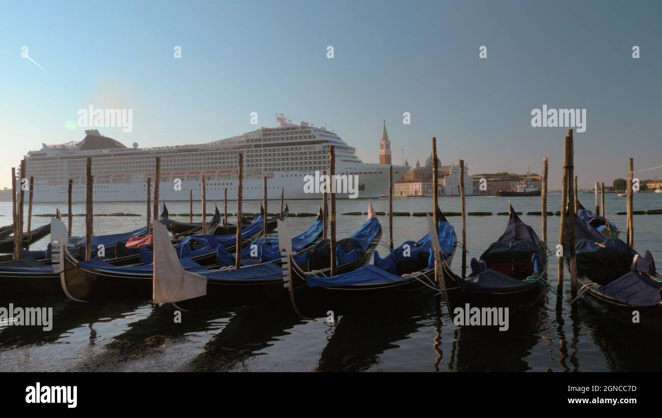 Cruise liner sailing in Venice, view with gondolas mooring Stock Photo ...