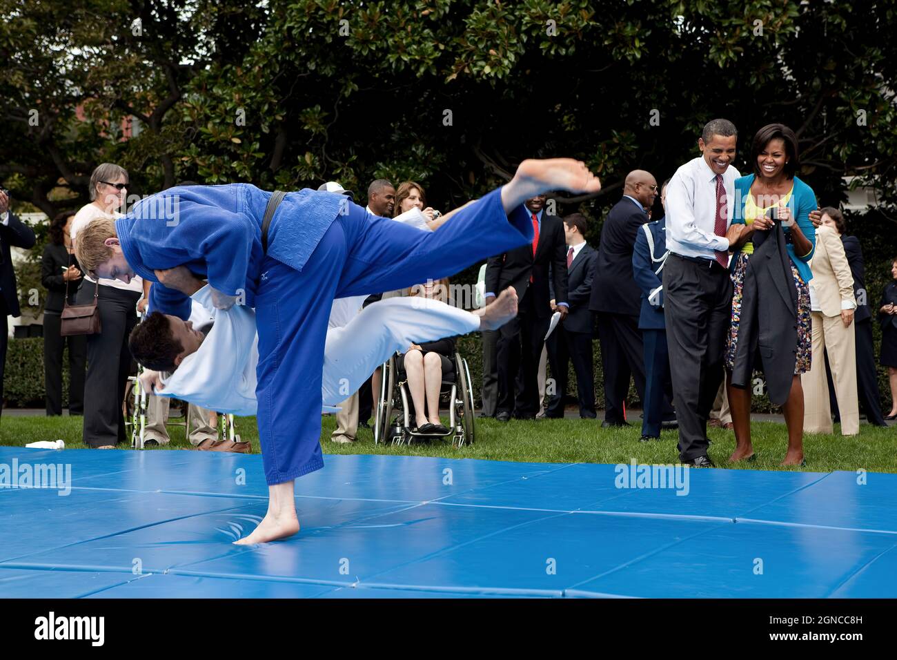 President Barack Obama and First Lady Michelle Obama watch Olympian Ryan Reser, in white, and Paralympian Myles Porter during a judo demonstration, part of the U.S
